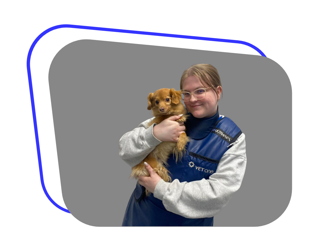 A woman holds a small dog